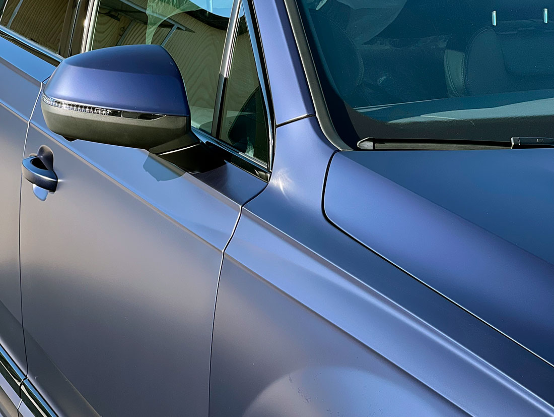Смотреть на фото дверь и крыло автомобиля Audi Q7 после оклейки антигравийной пленкой в детейлинге AR-Detailing.